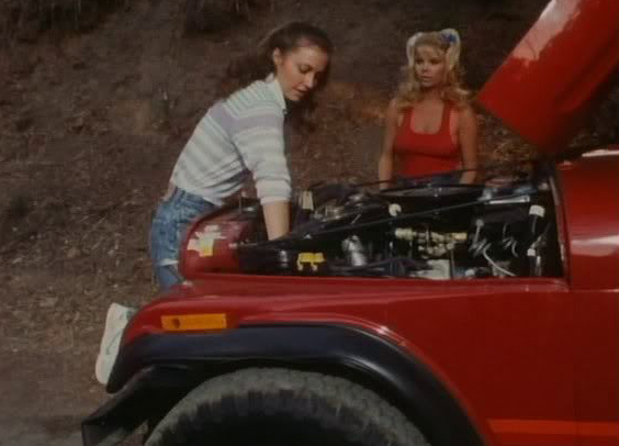 That's here on the right, taking charge as an attractive young woman tries to get an old banger fired up