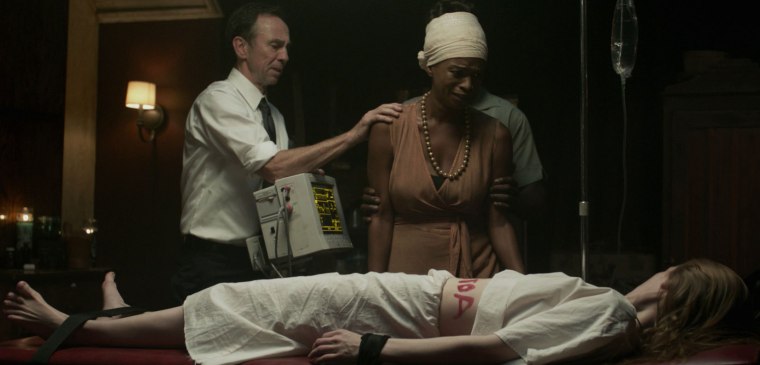 "We're doing all we can ma'am, but that shit tattooist really did a number on her stomach. Well, a word, to be precise"